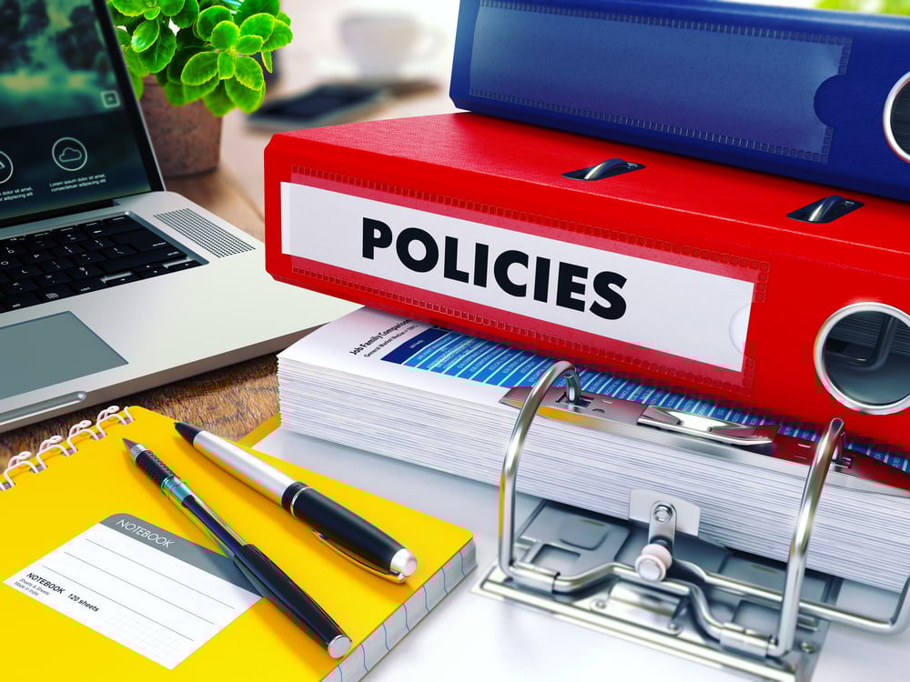 Policies - Red Ring Binder on Office Desktop with Office Supplies and Modern Laptop. Business Concept on Blurred Background. Toned Illustration. Policies - Red Ring Binder on Office Desktop with Office Supplies and Modern Laptop. Business Concept on Blurred Background. Toned Illustration.