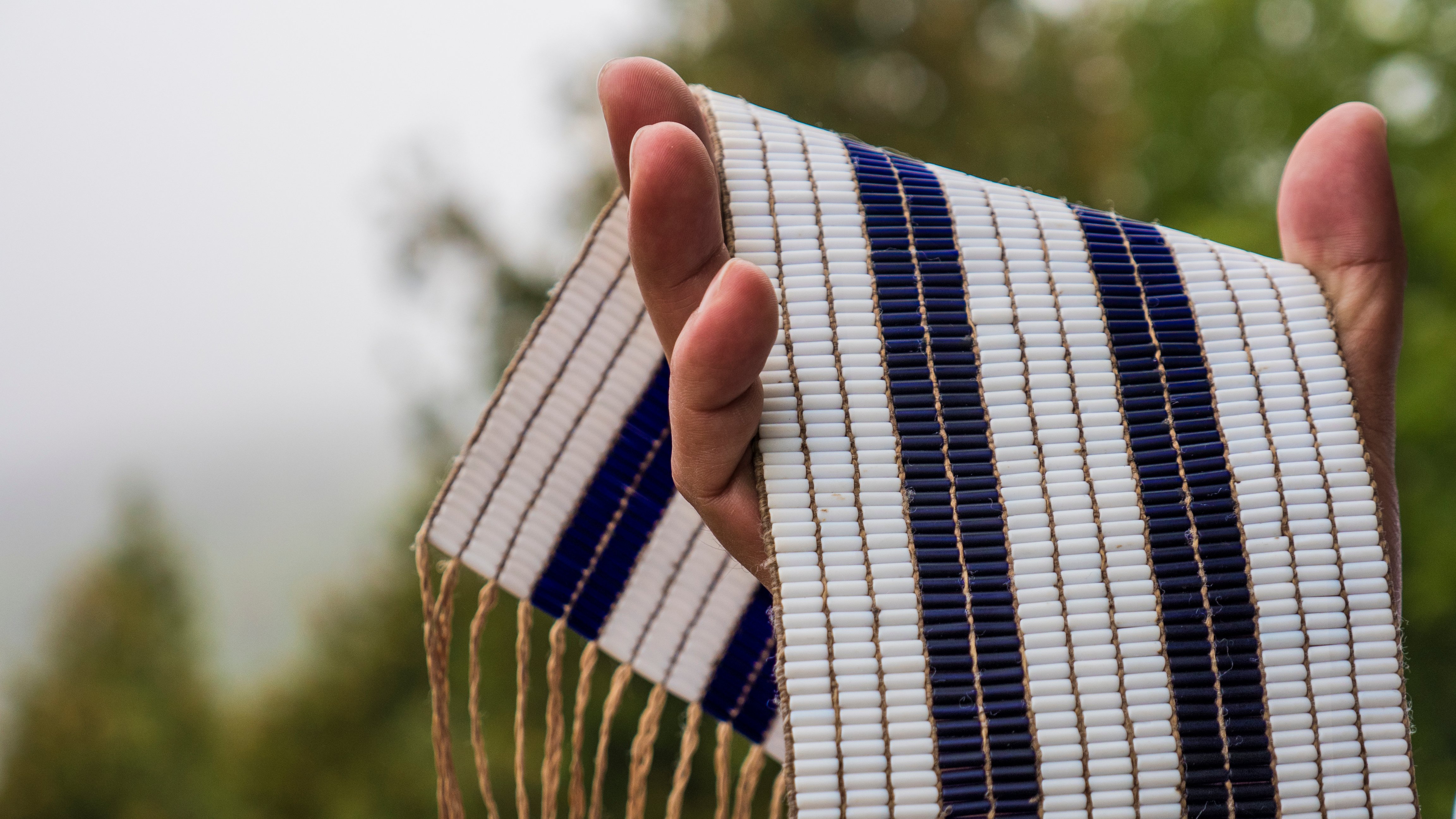 Hand holing blue and white wampum