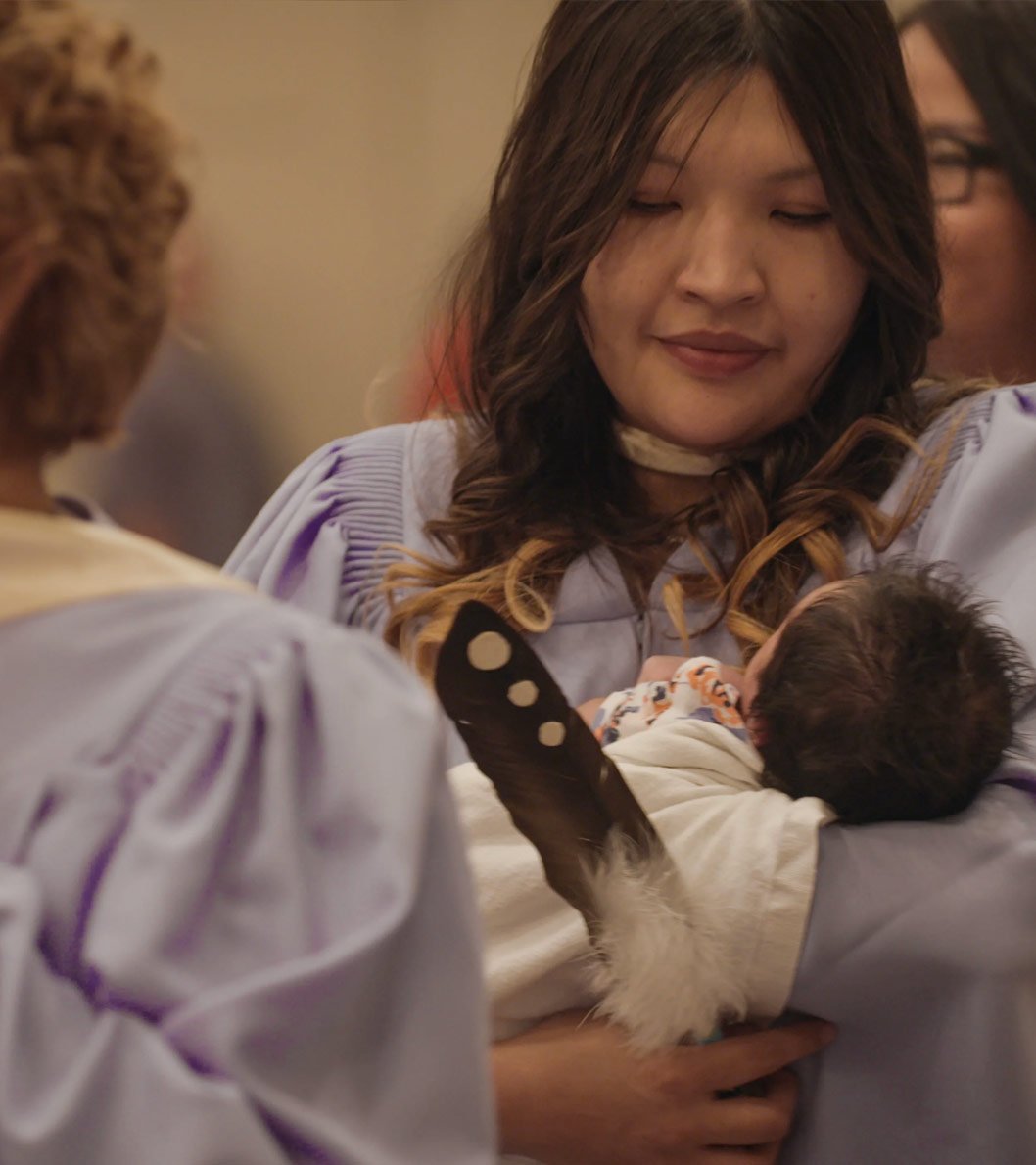 Indigenous woman holing a baby